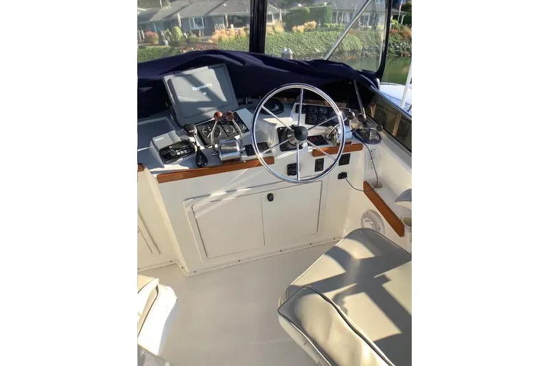Slide: The Image of 2001 Sabreline Sedan boat helm with steering wheel and navigation equipment. - 42