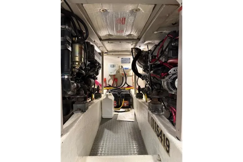 Slide: The Image of Engine room of a 2001 Sabreline Sedan boat, showcasing mechanical components and wiring. - 47