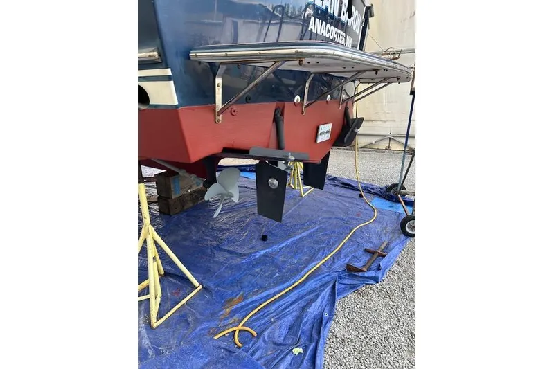 Slide: The Image of 2001 Sabreline Sedan boat on tarp, showing propeller and stern details. - 60
