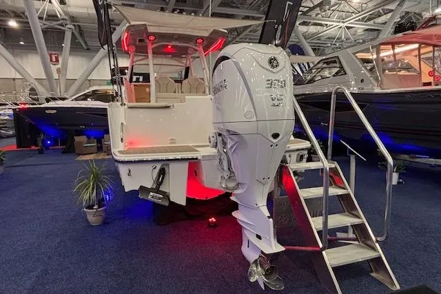 Slide: The Image of 2026 Solara S-250 CW boat with powerful outboard motor displayed at an indoor boat show. - 3