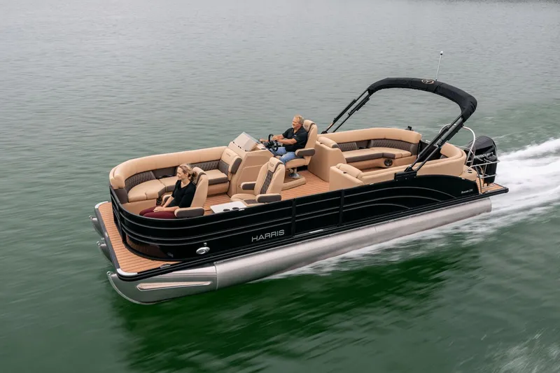 The Image of 2026 Harris Sunliner 250 pontoon boat cruising on calm water. - 0