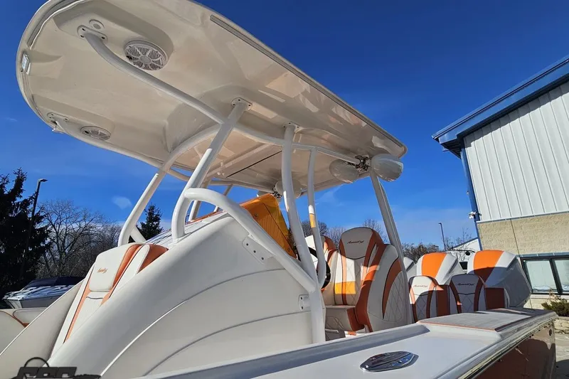 Slide: The Image of 2021 Avanti 36 Center Console boat with orange and white seating under a clear blue sky. - 13