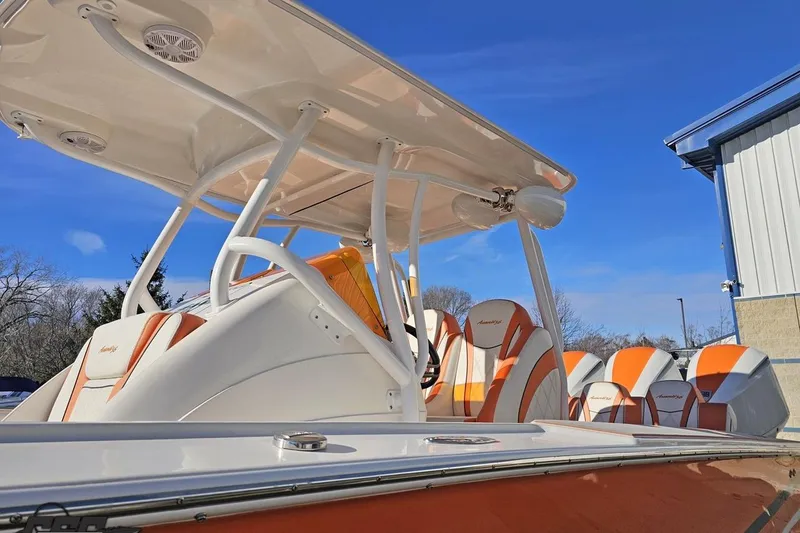 Slide: The Image of 2021 Avanti 36 Center Console boat with orange and white seating, under a clear blue sky. - 14