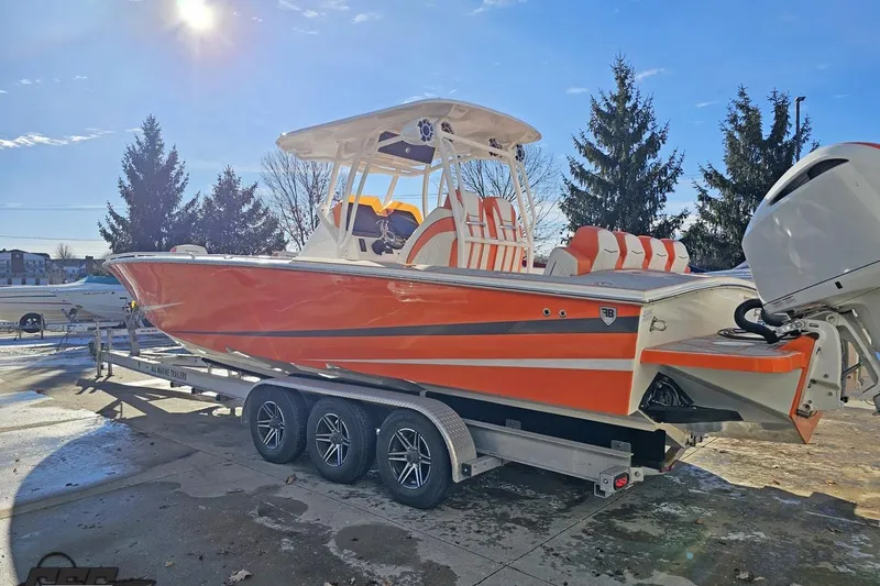 Slide: The Image of 2021 Avanti 36 Center Console boat with orange and white design on a trailer. - 16