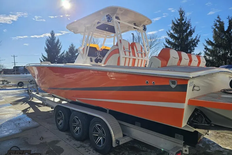 Slide: The Image of 2021 Avanti 36 Center Console boat with orange and white design on a trailer. - 17