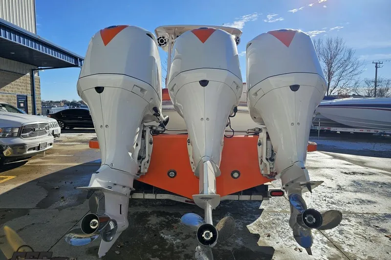 Slide: The Image of 2021 Avanti 36 Center Console with triple outboard engines, parked outdoors. - 18