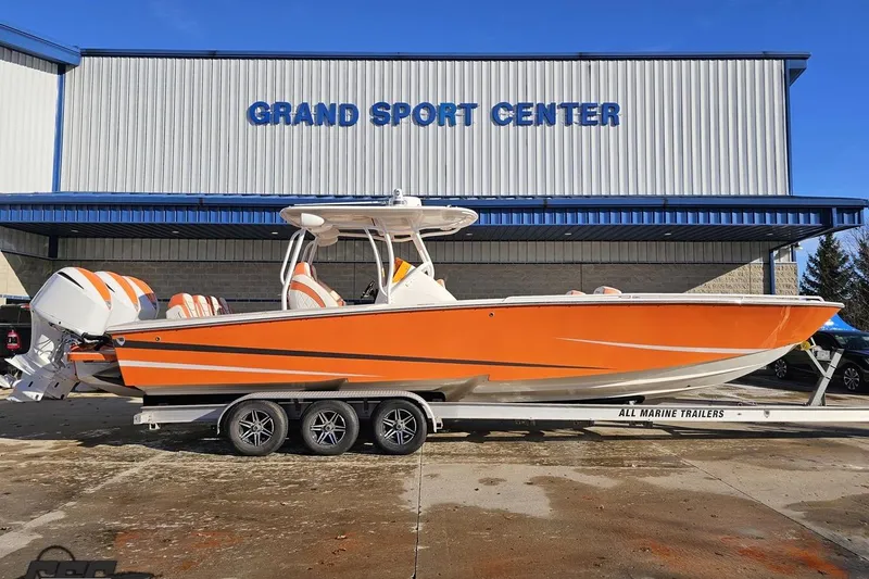 Slide: The Image of 2021 Avanti 36 Center Console boat in vibrant orange at Grand Sport Center. - 2