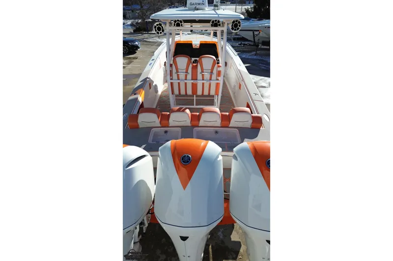 Slide: The Image of 2021 Avanti 36 Center Console boat with orange and white seating and triple outboard engines. - 23