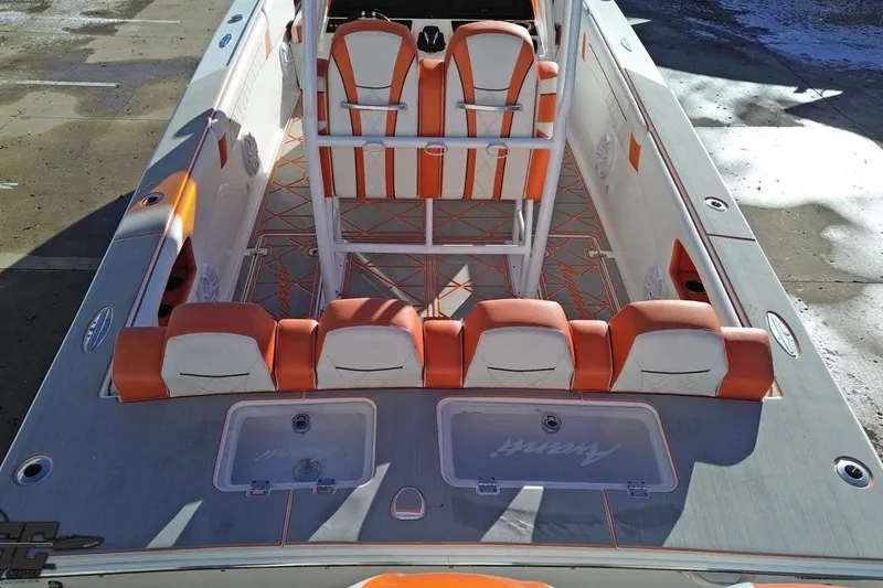 Slide: The Image of 2021 Avanti 36 Center Console boat with orange and white seating, docked on a sunny day. - 25