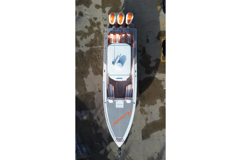 Slide: The Image of Top view of 2021 Avanti 36 Center Console boat with orange accents and triple engines. - 32