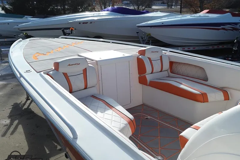 Slide: The Image of 2021 Avanti 36 Center Console boat with orange and white seating, docked outdoors. - 34