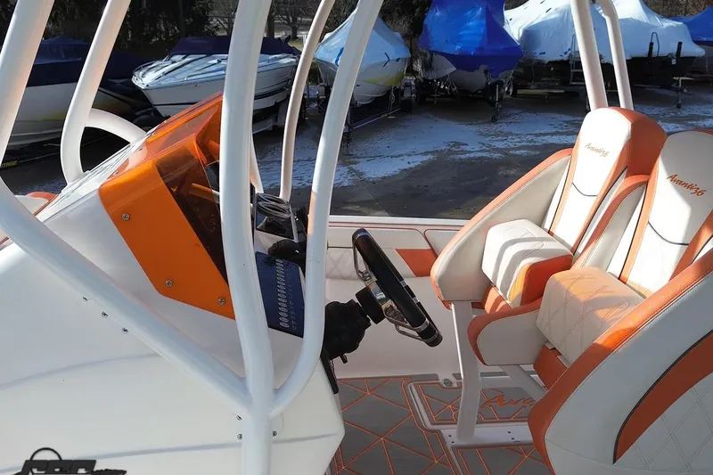 Slide: The Image of 2021 Avanti 36 Center Console interior with orange and white seating, steering wheel, and dashboard. - 35