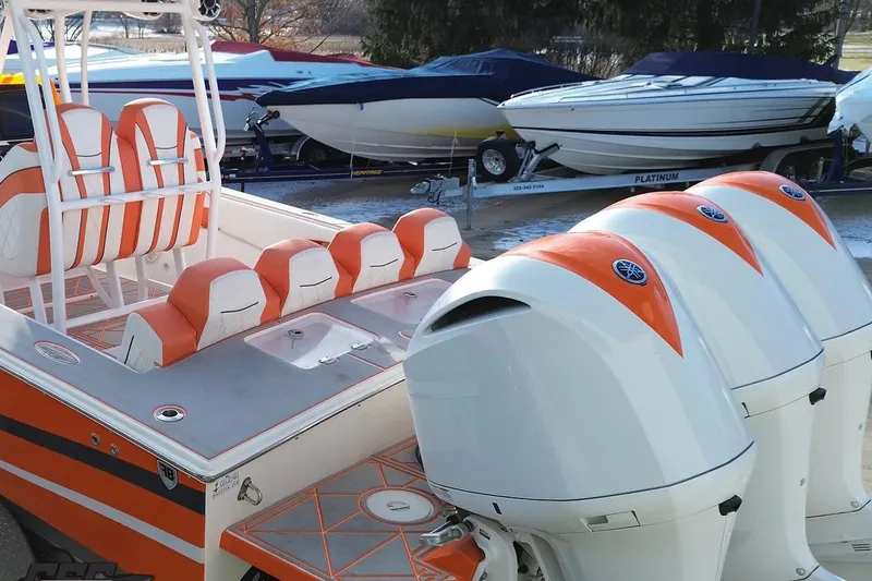 Slide: The Image of 2021 Avanti 36 Center Console boat with orange and white seating and triple outboard engines. - 38