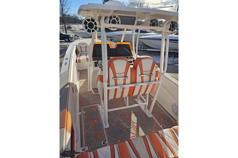 Slide: The Image of 2021 Avanti 36 Center Console boat interior with orange and white seating and modern dashboard. - 39