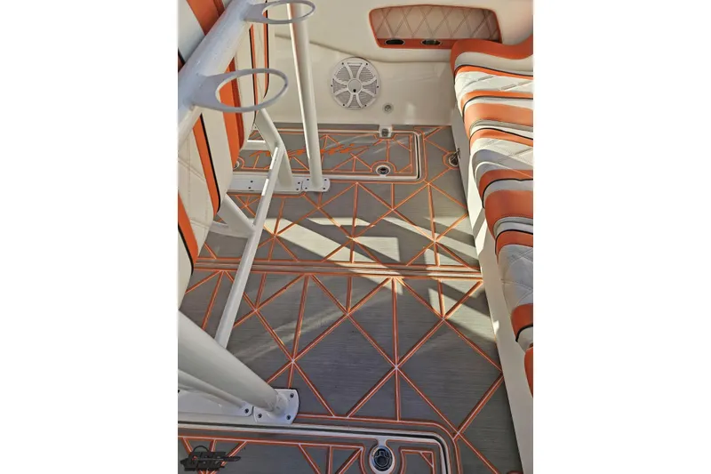 Slide: The Image of 2021 Avanti 36 Center Console interior with orange accents and geometric flooring design. - 43