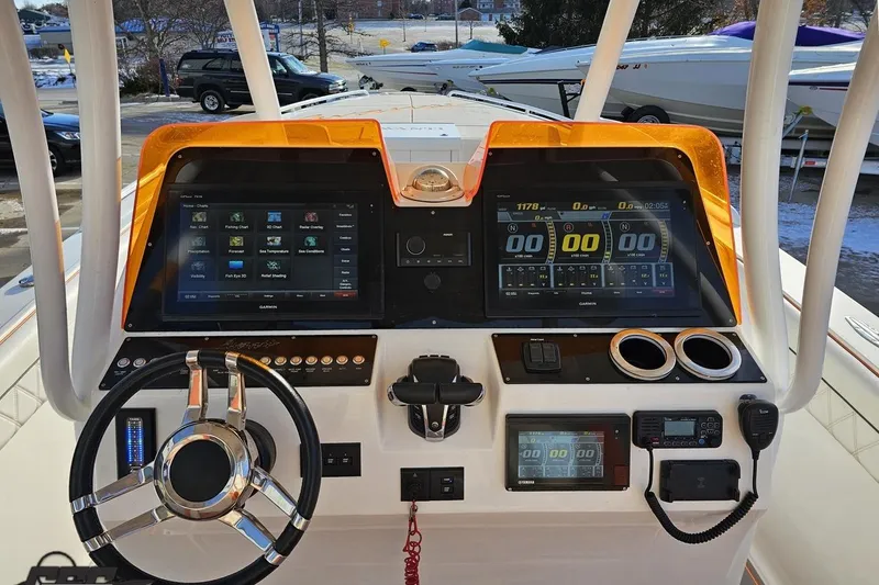 Slide: The Image of 2021 Avanti 36 Center Console boat dashboard with advanced navigation displays and controls. - 47
