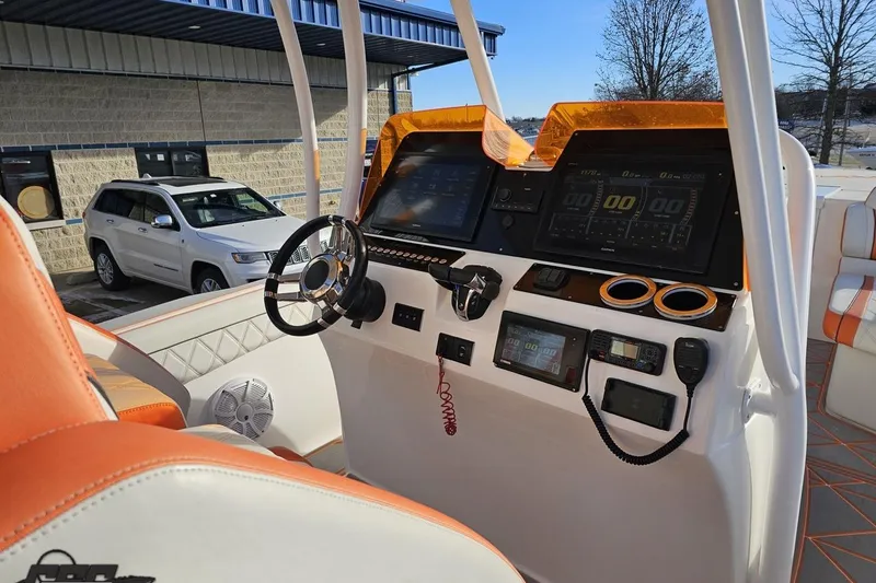 Slide: The Image of 2021 Avanti 36 Center Console boat dashboard with modern controls and orange accents. - 48