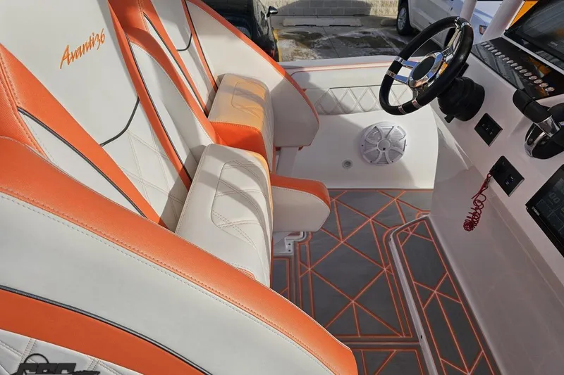 Slide: The Image of 2021 Avanti 36 Center Console interior with orange and white seating, modern dashboard. - 49