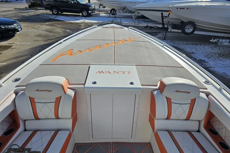 Slide: The Image of 2021 Avanti 36 Center Console boat with orange and white seating, docked in a marina. - 57