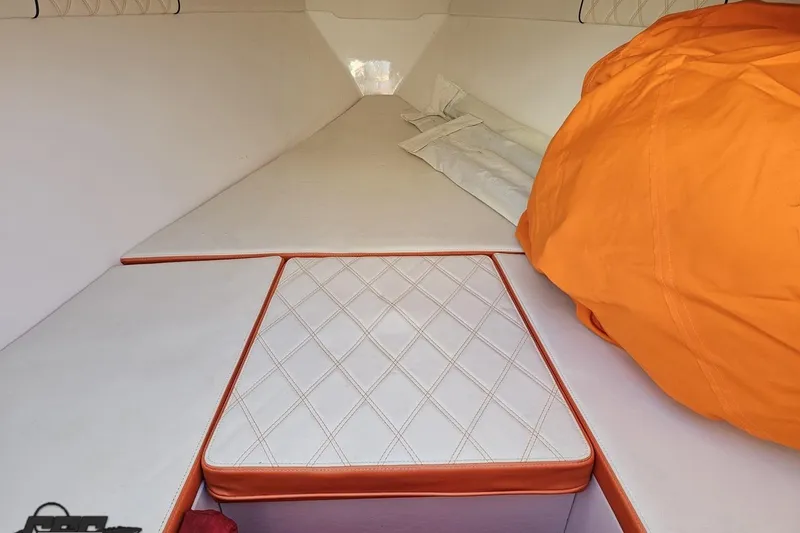 Slide: The Image of 2021 Avanti 36 Center Console cabin interior with orange accents and quilted upholstery. - 61