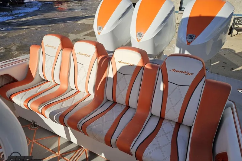 Slide: The Image of 2021 Avanti 36 Center Console boat with orange and white seating and triple outboard engines. - 73