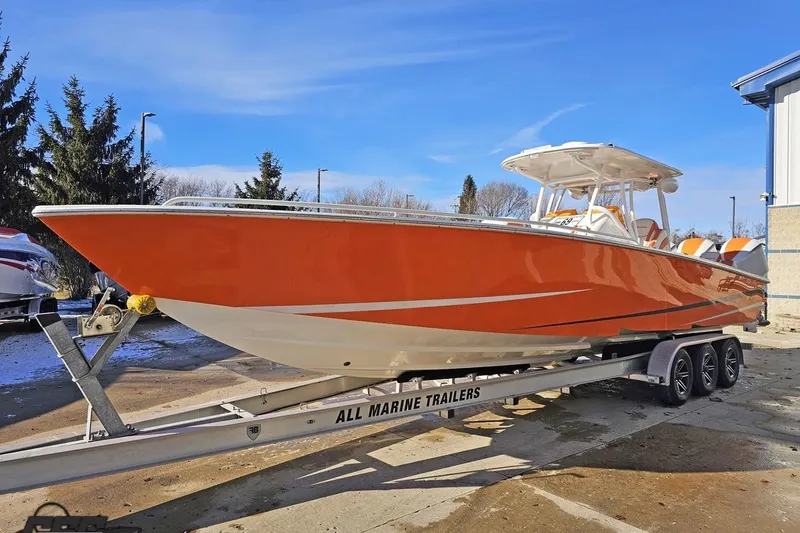 Slide: The Image of Orange 2021 Avanti 36 Center Console boat on trailer, parked outdoors. - 9
