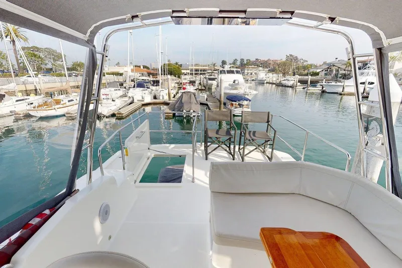 Slide: The Image of Beneteau Swift Trawler 35, 2021 model, docked in a marina with seating area. - 17