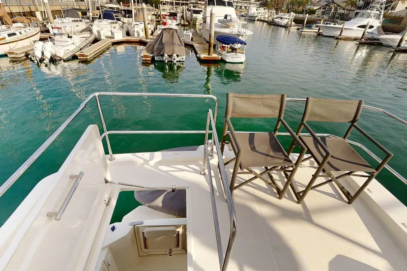 Slide: The Image of Flybridge view of 2021 Beneteau Swift Trawler 35, overlooking marina with docked boats. - 21
