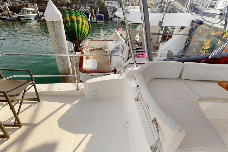 Slide: The Image of 2021 Beneteau Swift Trawler 35, spacious deck with seating, docked at marina. - 23