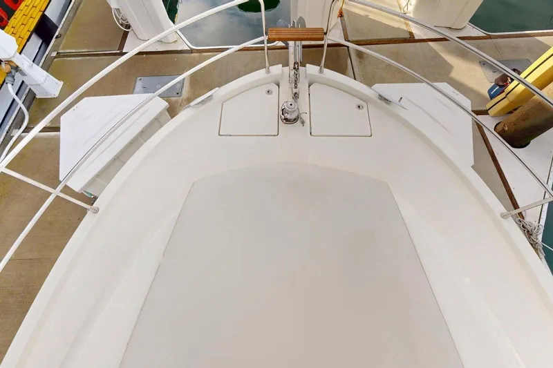 Slide: The Image of 2021 Beneteau Swift Trawler 35 bow view, showcasing deck and railing details. - 25