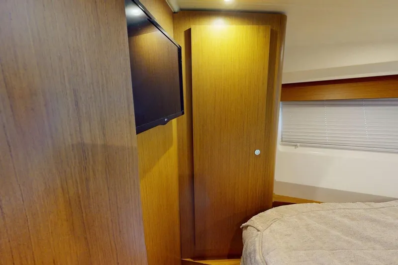 Slide: The Image of 2021 Beneteau Swift Trawler 35 cabin interior with wood paneling and TV. - 29