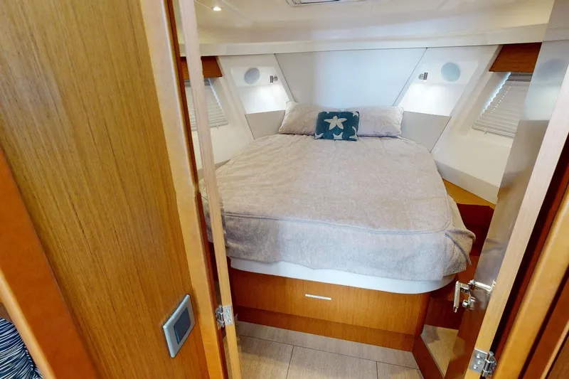 Slide: The Image of 2021 Beneteau Swift Trawler 35 cabin with cozy bed and nautical decor. - 31