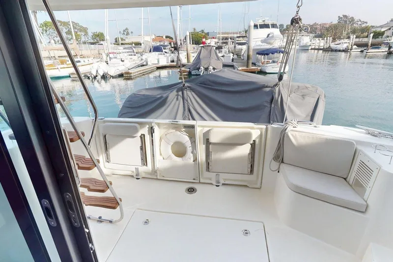 Slide: The Image of 2021 Beneteau Swift Trawler 35, rear deck view in marina setting. - 35