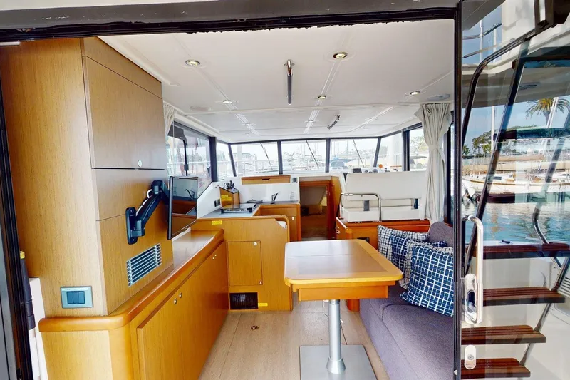 Slide: The Image of Interior of 2021 Beneteau Swift Trawler 35, featuring modern wood finishes and comfortable seating. - 38