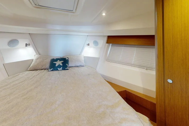 Slide: The Image of Cozy bedroom interior of 2021 Beneteau Swift Trawler 35 with starfish-themed pillow. - 43