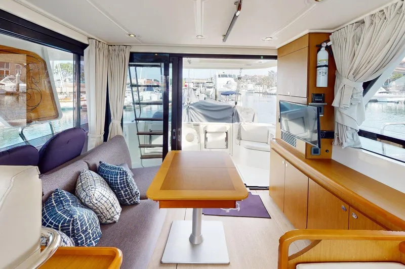 Slide: The Image of Interior of 2021 Beneteau Swift Trawler 35, featuring modern seating and a view of the marina. - 44