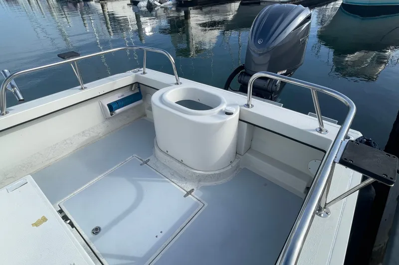 Slide: The Image of 1993 Davis Radoncraft boat interior with motor, docked at marina. - 10