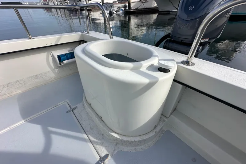 Slide: The Image of 1993 Davis Radoncraft boat deck with a built-in livewell and railing. - 11