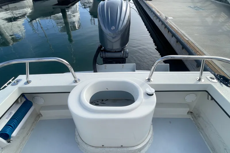 Slide: The Image of 1993 Davis Radoncraft boat stern with motor and dock view. - 12