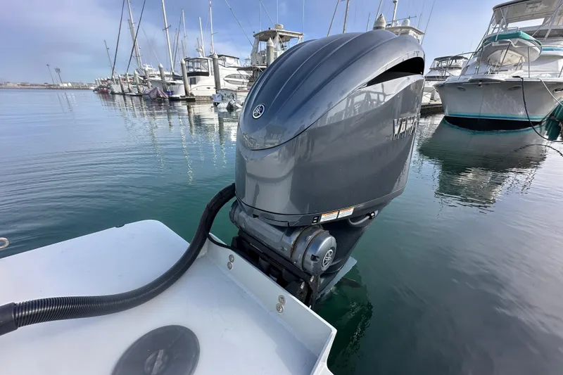 Slide: The Image of Boat engine on a Davis Radoncraft 1993, docked in a marina with yachts. - 13