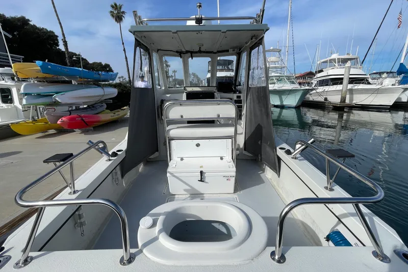 Slide: The Image of 1993 Davis Radoncraft boat docked at marina, surrounded by other vessels and kayaks. - 18