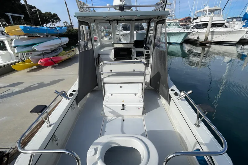 Slide: The Image of 1993 Davis Radoncraft boat interior at marina, featuring seating and control panel. - 19