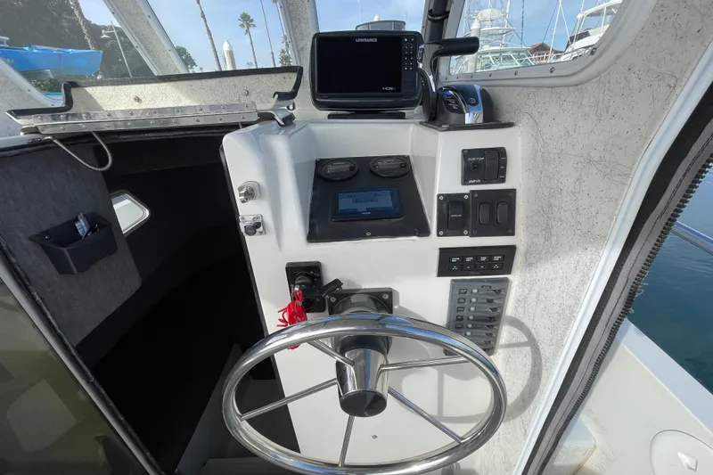 Slide: The Image of 1993 Davis Radoncraft boat helm with steering wheel, navigation controls, and electronic display. - 21