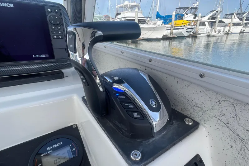 Slide: The Image of Boat control panel with Yamaha throttle, Lowrance display, and marina view. Davis Radoncraft 1993. - 23