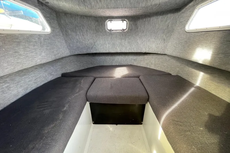 Slide: The Image of Interior cabin of 1993 Davis Radoncraft boat with cushioned seating and windows. - 32