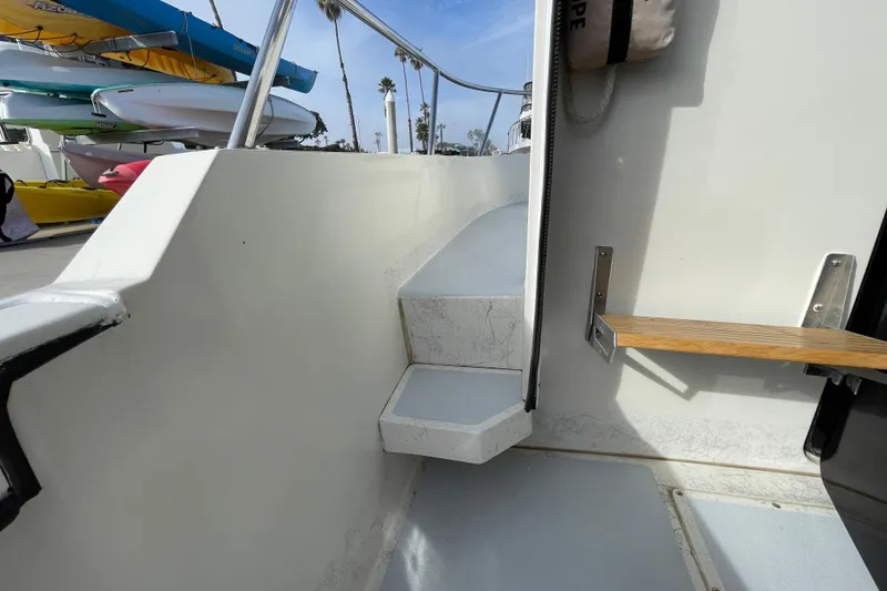 Slide: The Image of 1993 Davis Radoncraft boat interior with steps and railing, docked near colorful kayaks. - 35