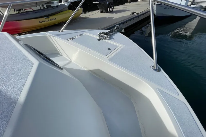 Slide: The Image of 1993 Davis Radoncraft boat bow with anchor, docked near kayaks. - 38