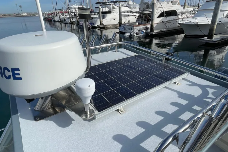 Slide: The Image of 1993 Davis Radoncraft boat with solar panel and radar, docked at marina. - 40