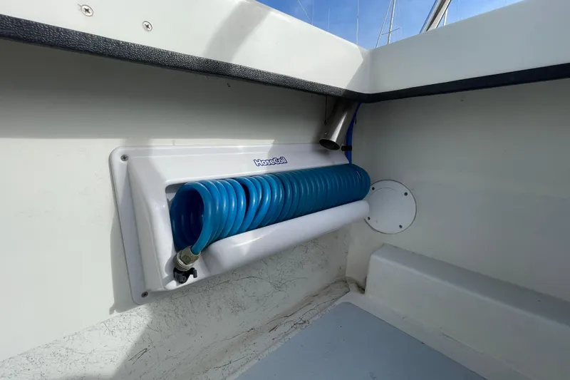 Slide: The Image of Coiled blue hose in a 1993 Davis Radoncraft boat interior. - 41