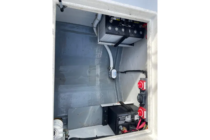 Slide: The Image of Battery compartment of a 1993 Davis Radoncraft boat, featuring wiring and switches. - 43